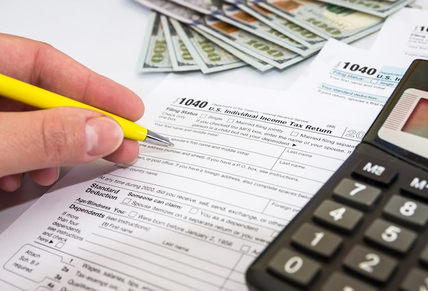 Premium Photo Close Up Of Female Hand Fills Out Tax Forms On White