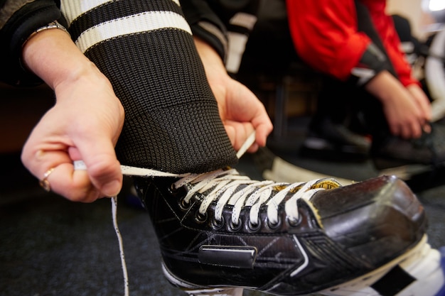 Premium Photo Close Up Of Female Hockey Player Putting On Gear