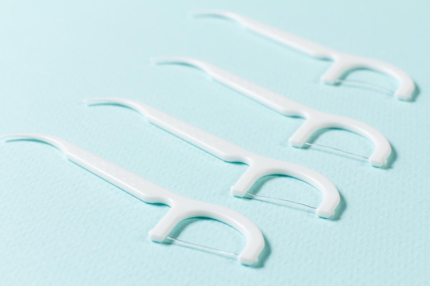 Premium Photo | Close-up flossing toothpicks on the blue background