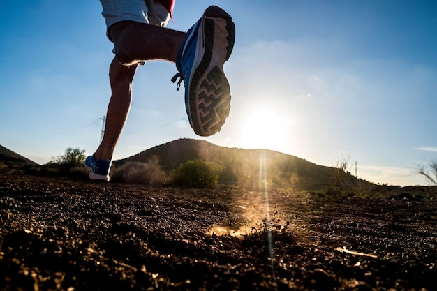 Premium Photo | Close up of foot of man running alone in the mountains ...