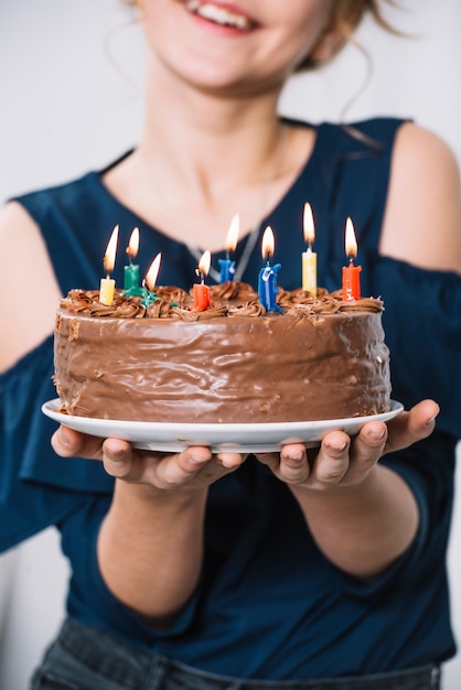 Close Up Of Girl S Hand Holding Plate Of Chocolate Cake With