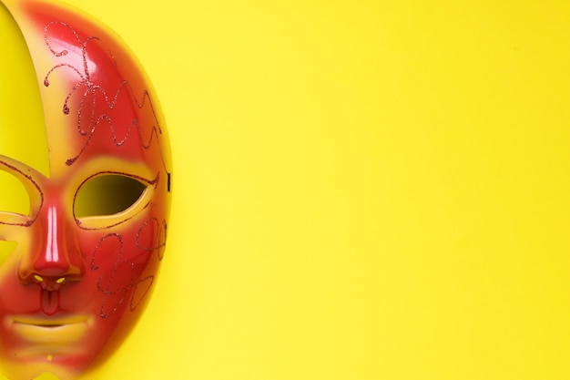 Download Close Up Half Mask On Yellow Free Photo PSD Mockup Templates