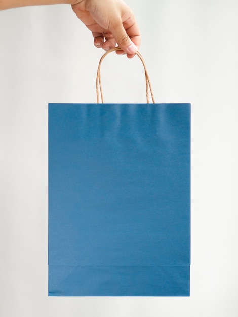 Download Close-up hand holding a blue bag mock-up Photo | Free Download