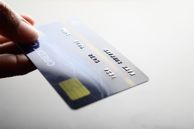 Close up of hand holding credit card Free Photo