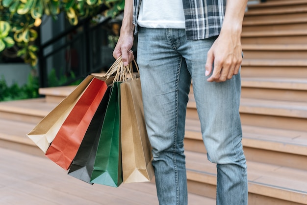 Free Photo Close Up Hand Of Male Holding Multiple Shopping Bag