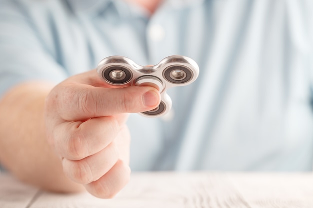 Close-up of a hand s man holding a fidget spinner Premium Photo