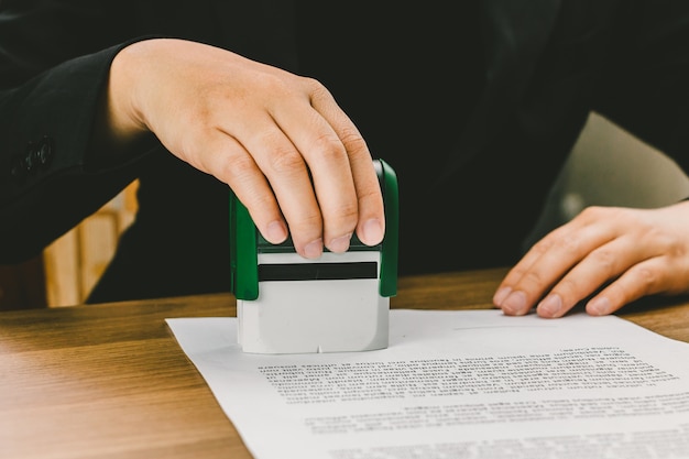 Premium Photo | Close-up hand stamping of businesswoman for signing  approval on documents