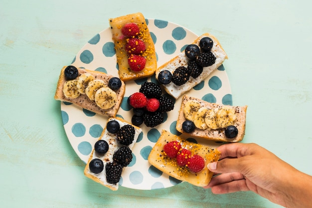 Free Photo | Close-up hand taking a morning snack