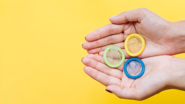 Free Photo Close Up Hands Holding Condoms With Copy Space