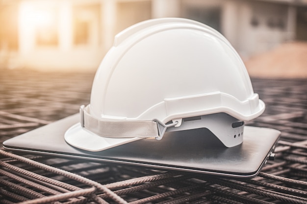 Download Free Close Up Hard Hat On Laptop At Real Estate Construction Site Use our free logo maker to create a logo and build your brand. Put your logo on business cards, promotional products, or your website for brand visibility.