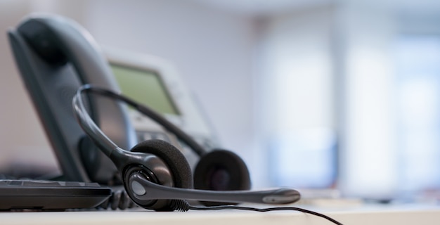 Premium Photo Close Up On Headset Call Center With Telephone At Office Monitoring Operation Room Concept