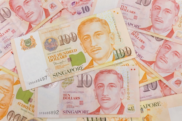 Premium Photo | Close up of a heap of singapore money and background ...