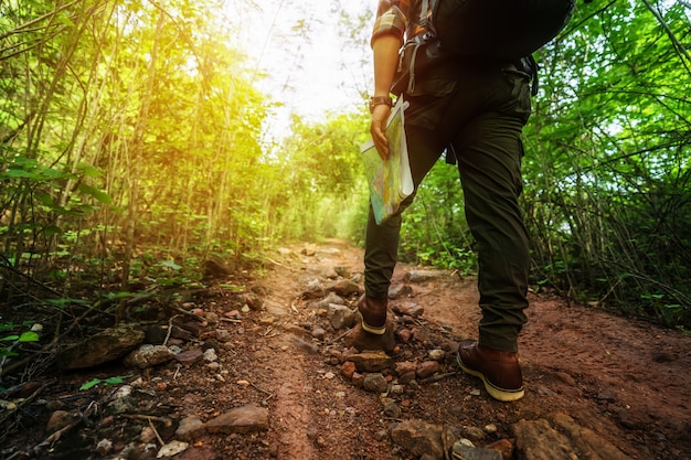 Close up hiking man with trekking boots walking in the forest Premium Photo