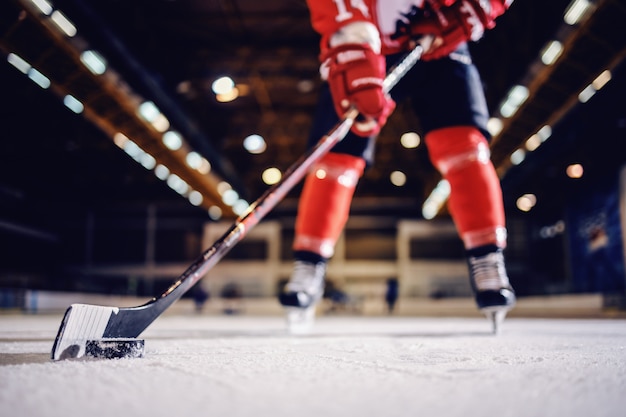 Premium Photo Close Up Of Hockey Player Skating With Stick And Puck