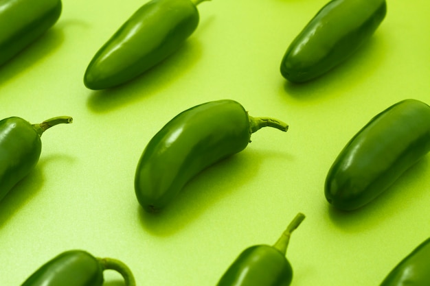 Close-up jalapenos on green background Photo | Free Download