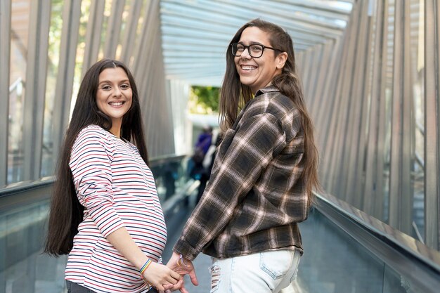 Premium Photo Close Up Of Lesbian Pregnant Couple Holding Hands Outdoors