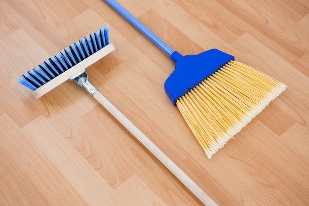 Premium Photo | Close up of long handle brooms