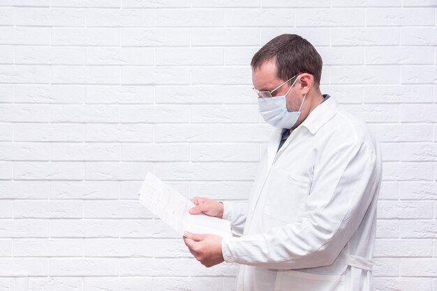 Premium Photo | Close up male doctor holding paper