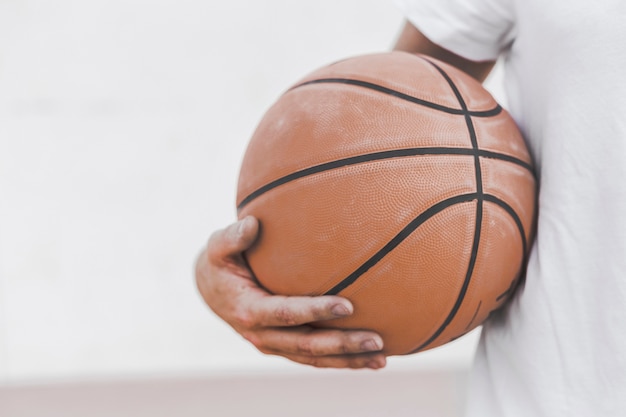 Free Photo Close Up Of A Male Player S Hand Holding Basketball