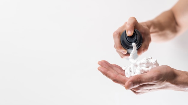 Close up man applying shaving foam on hand Photo | Free Download