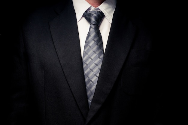 Premium Photo | Close up of man in black suit, shirt and tie on black ...