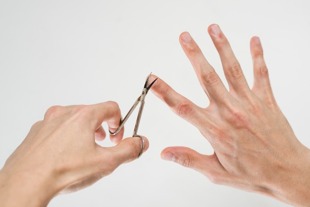 Close up of a man cutting his nails Photo | Free Download