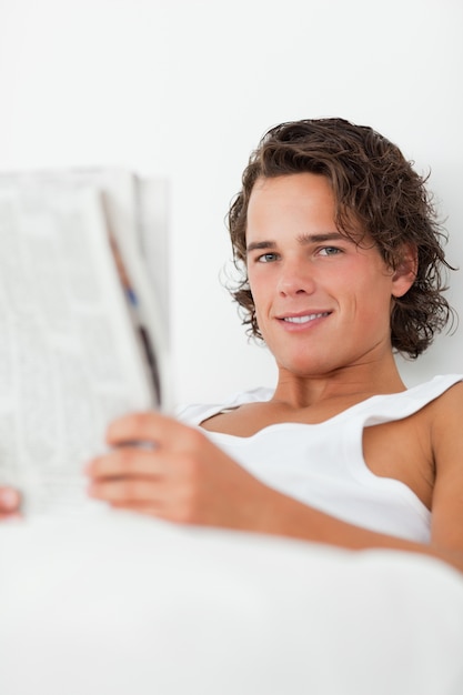 Premium Photo | Close up of a man holding a newspaper