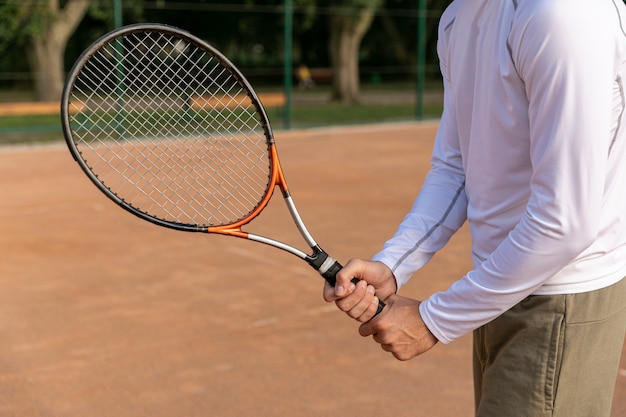 Free Photo | Close-up man holding tennis racket