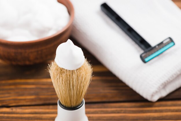 Free Photo | man's shaving with napkin on wooden table