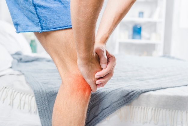 Premium Photo Close Up Of A Man Standing Near The Bed Suffering From   Close Up Man Standing Near Bed Suffering From Pain Knee 23 2147948563 