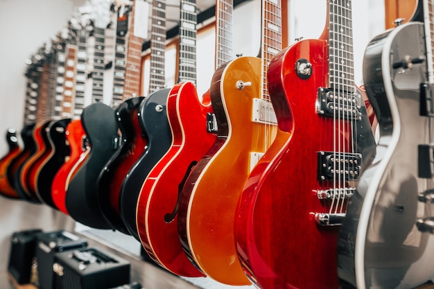 Premium Photo | Close up of many electric guitars in a row in the ...