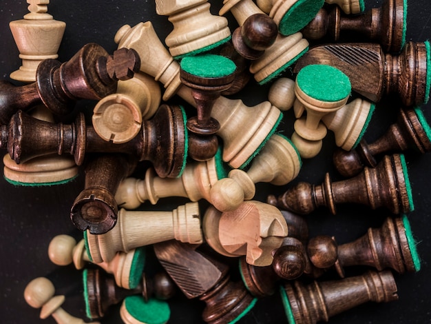 Premium Photo | Close up messy chess pieces on the dark black table ...