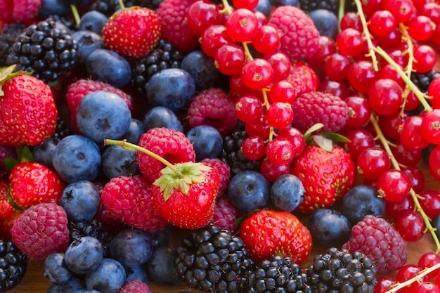 Premium Photo | Close up on mix of piles of fresh berries