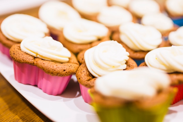 Free Photo Closeup Muffins With Whipped Cream Icing