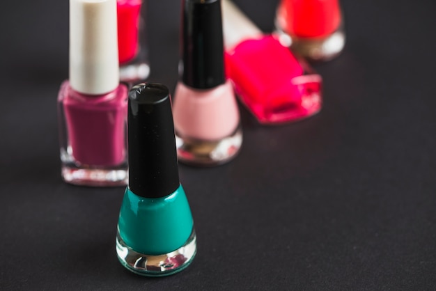 Premium Photo | Close-up of nail varnish bottles on black background