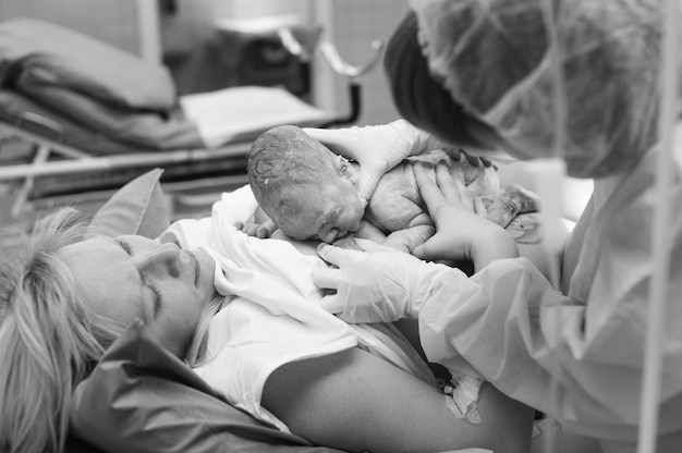 premium-photo-close-up-of-a-newborn-feeding-on-the-mother-s