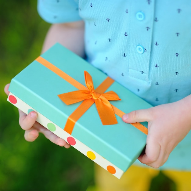 Premium Photo | Close-up of nicely wrapped birthday gift being held by ...