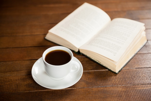 Close-up Of Coffee Cup And Book Photo 