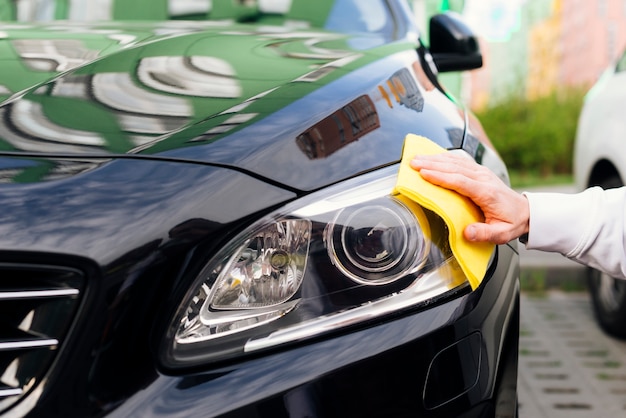 Premium Photo | Close up of person cleaning car exterior