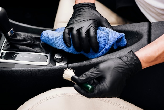 Close up of person cleaning car interior | Free Photo