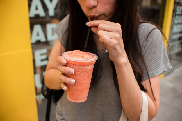 Close-up person drinking juice Photo | Free Download