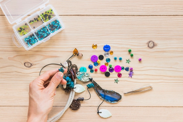 Free Photo | Close-up of person's hand making handmade jewelry on ...