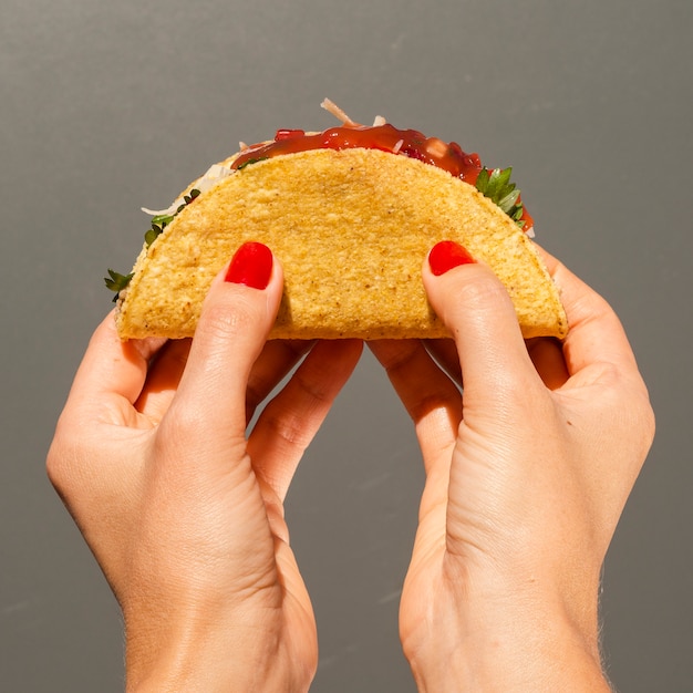 Free Photo | Close-up person with taco and grey background