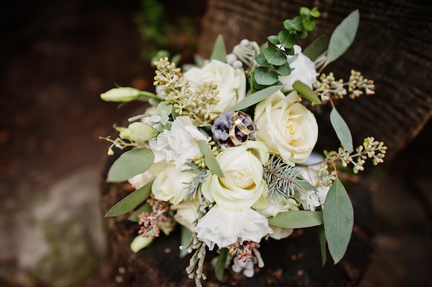 Premium Photo Close Up Photo Of Wedding Bouquet Made Of White Roses And Other Herbs Laying On Wooden Surface