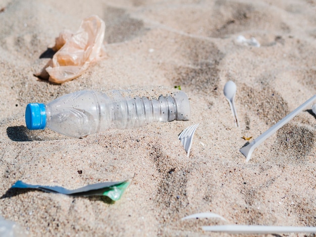 Close-up of plastic garbage on sand at outdoors Photo | Free Download