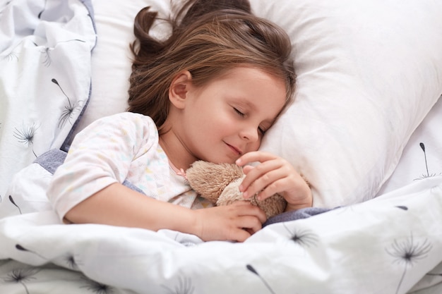 cute baby sleeping with teddy