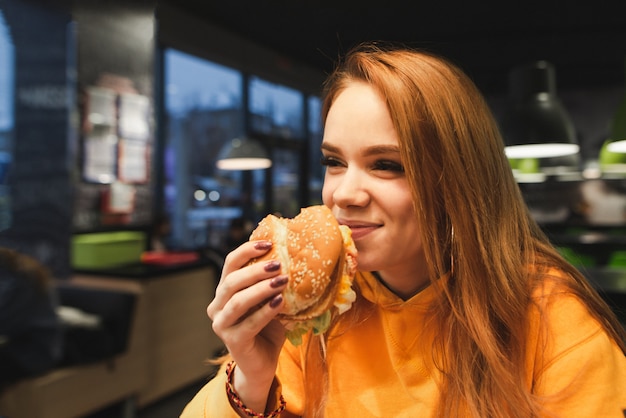 Premium Photo | Close-up portrait of a girl holding a great tasty ...