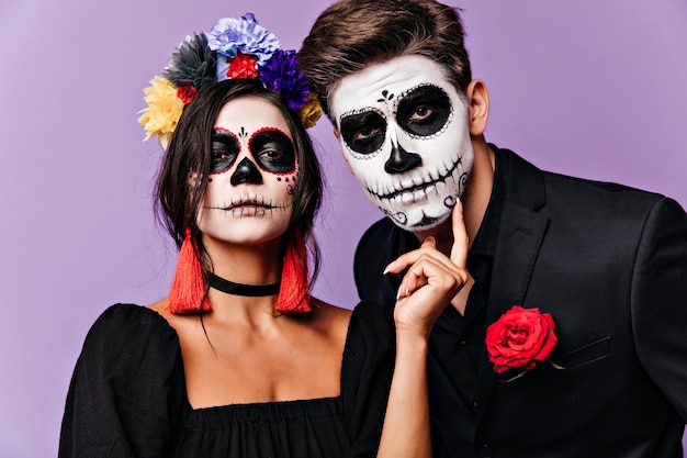 Free Photo | Close-up portrait of mexican guy and girl with face art. couple in unusual clothes ...