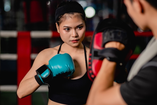 Free Photo Close Up Portrait Young Pretty Woman Exercising With Handsome Trainer At Boxing And Self Defense Class On The Boxing Ring At The Gym Female And Male Fight Acting Selective