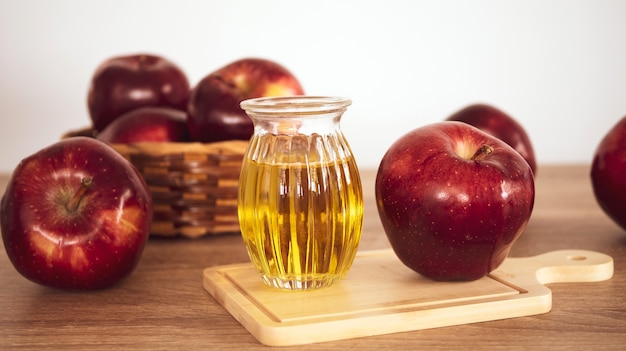 Close up red apple fruit and apple cider vinegar juice ...